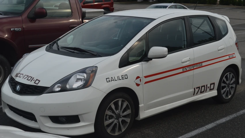 a white and red vehicle parked in a parking lot