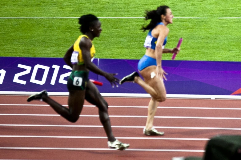 two women are running together on a track