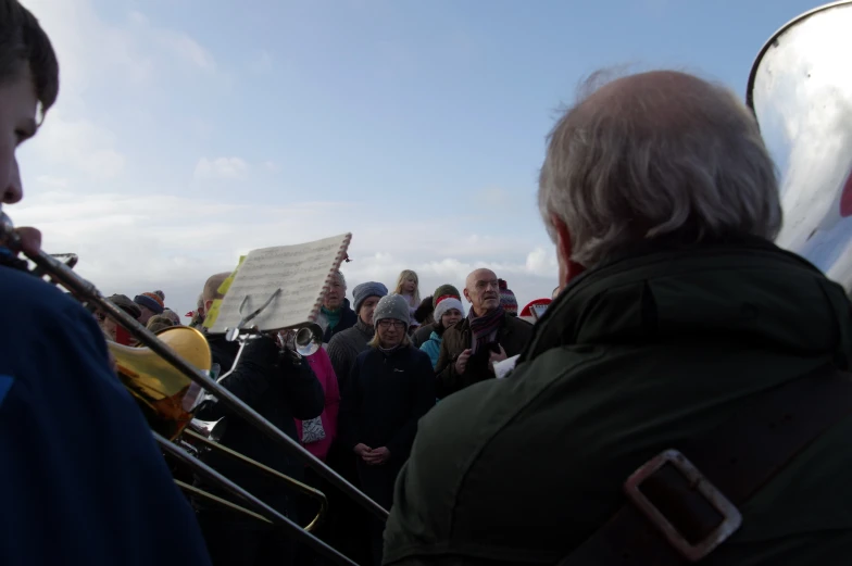 there is a band playing while people watch from the front row