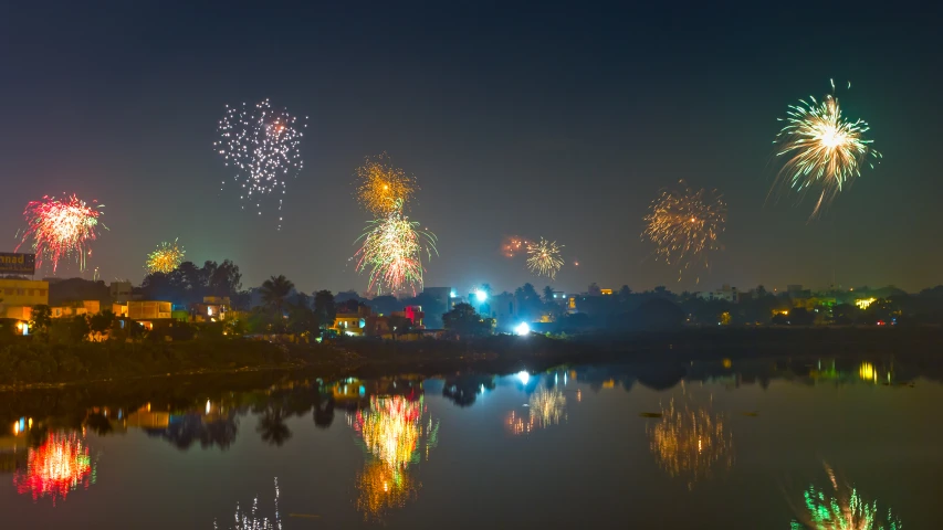 fireworks are lit up from the sky above water