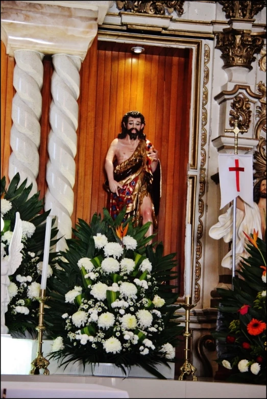 a statue of jesus in a church surrounded by candles
