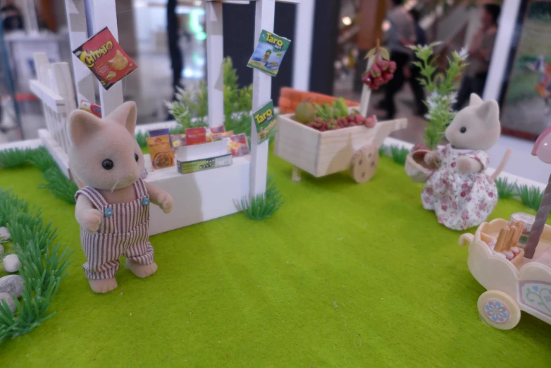 several small toys in front of a small shop