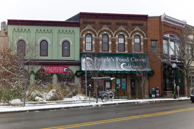 an old brick building with the front covered in snow