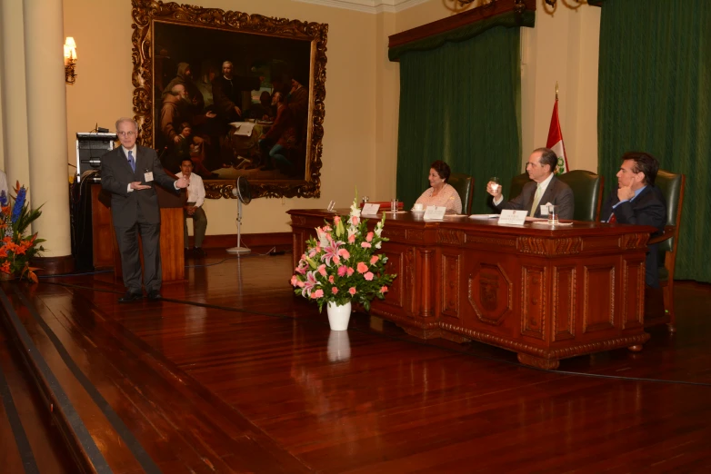 people sitting around tables in a large room