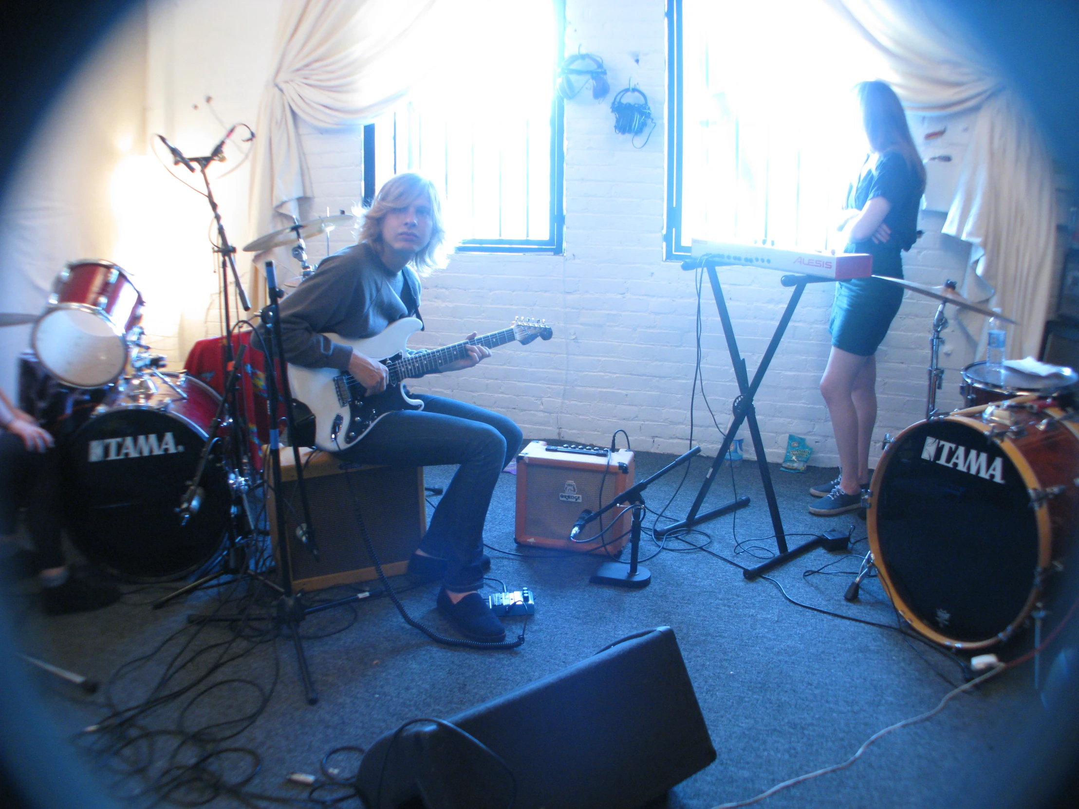 two women sitting on chairs with their guitars