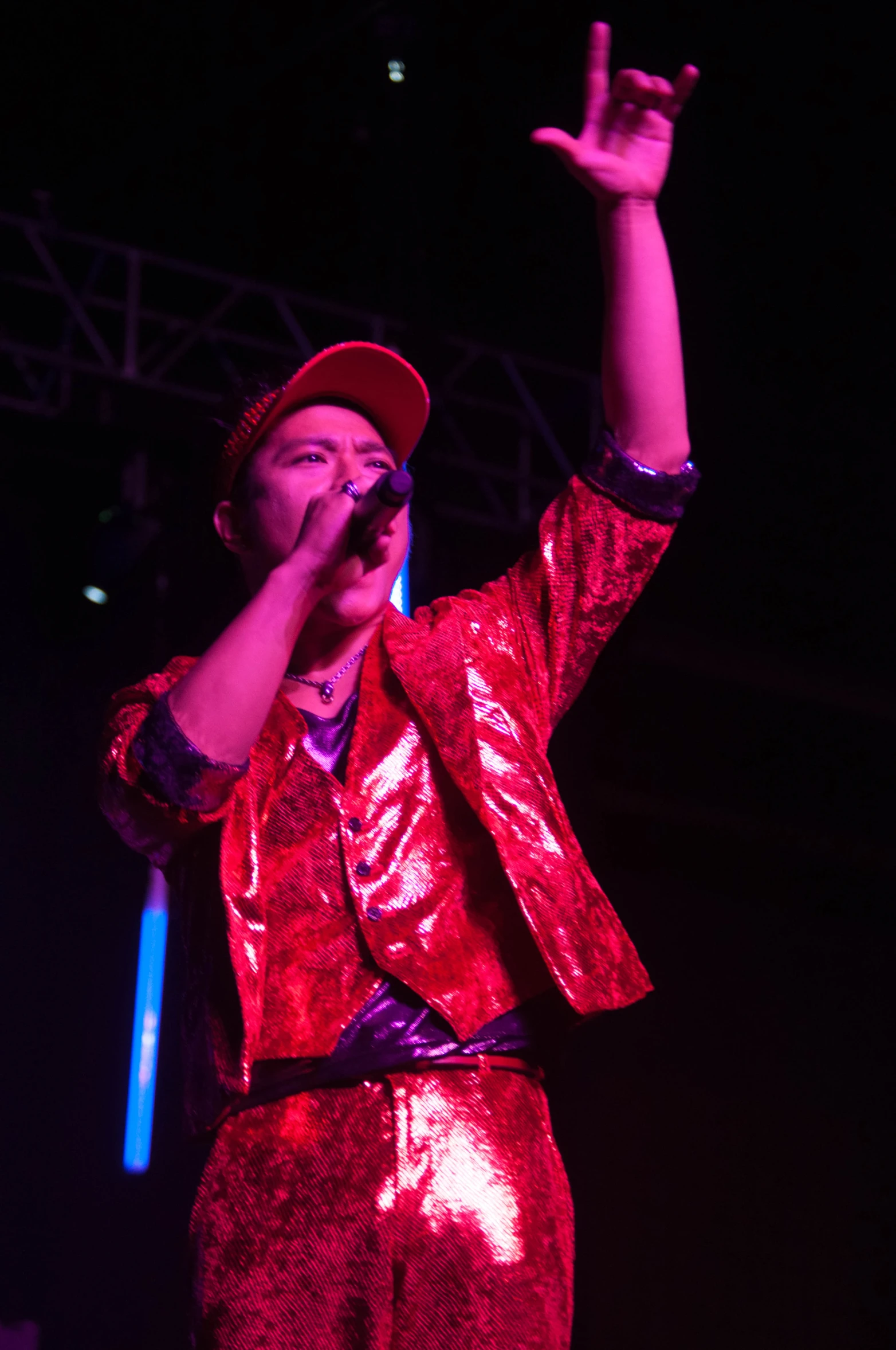 a man in a red jacket and pants on a stage