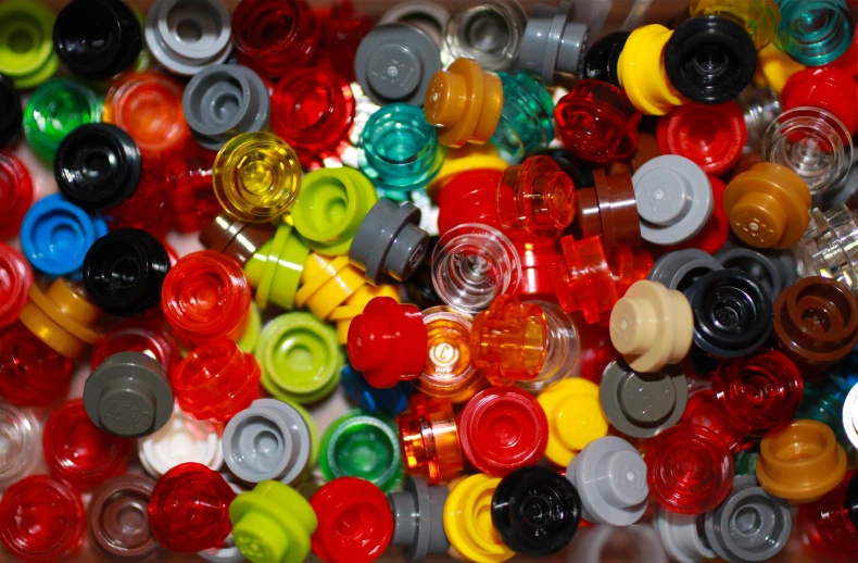 several large assortment of different colored plastic bottles