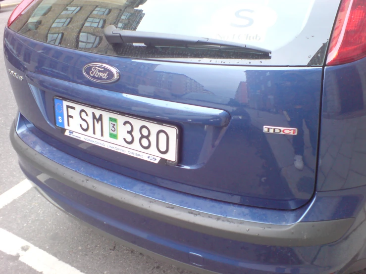 a blue ford focus parked in a parking lot