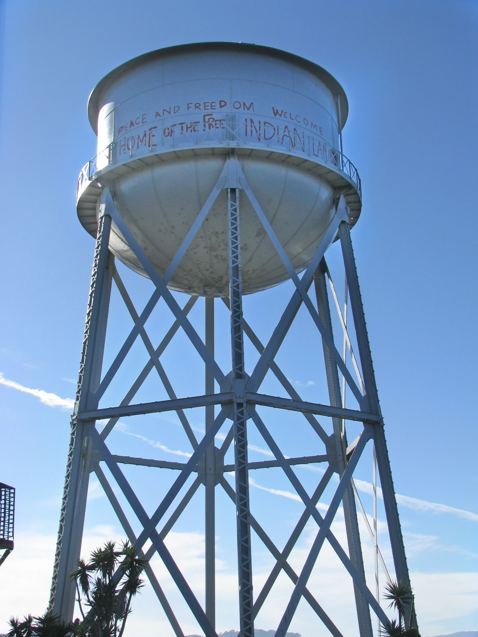 a very tall white water tower against a blue sky