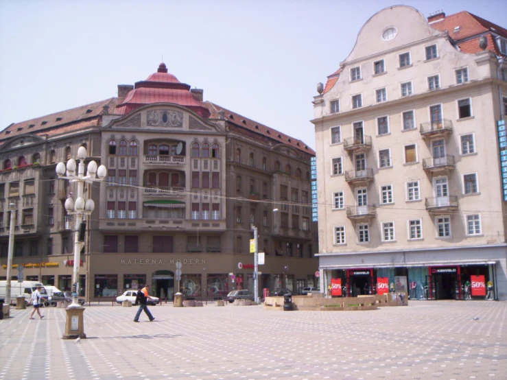 several buildings with balconies and some people walking