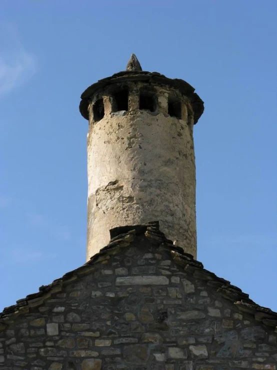 a stone wall has a tower like structure on top