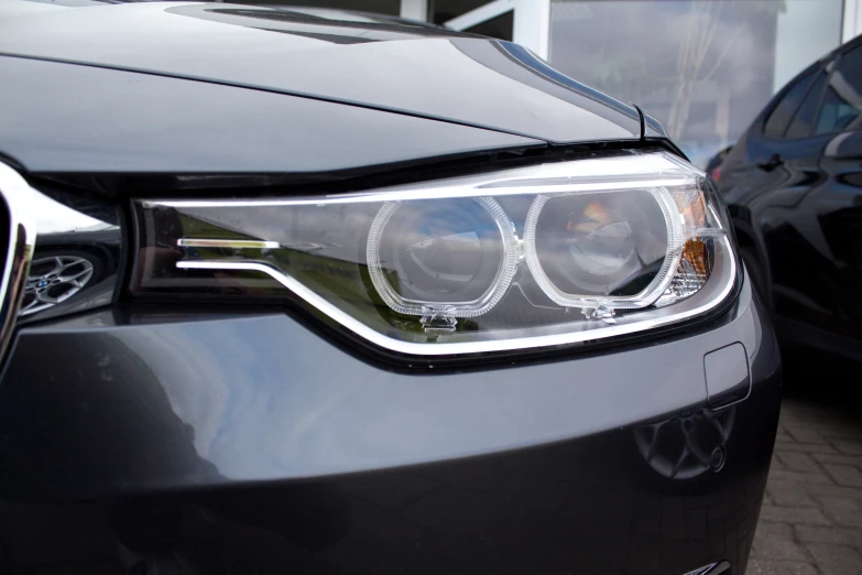 headlights and grills on black car in urban area