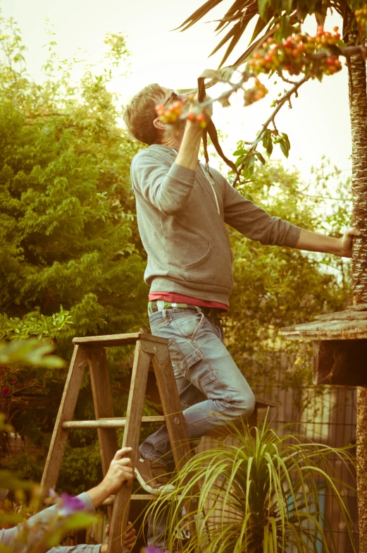 a man that is climbing up the side of a ladder