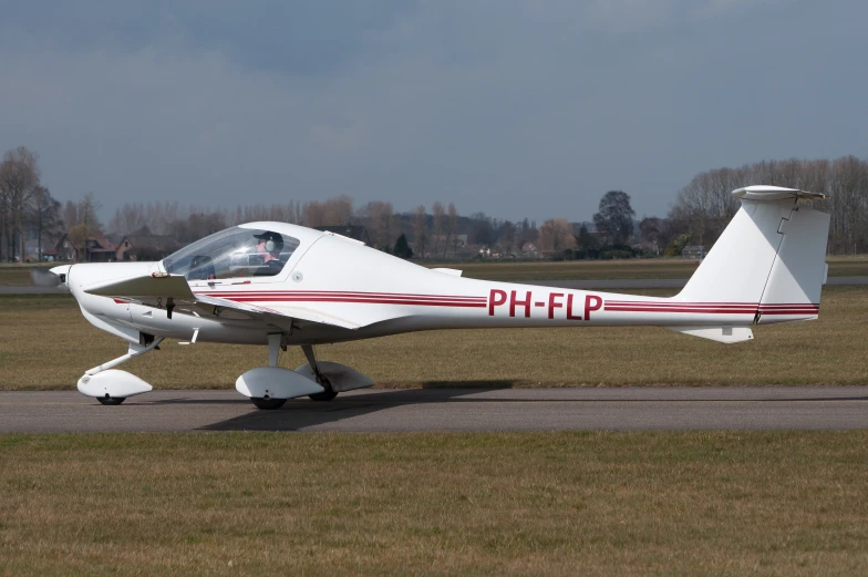 a small prop plane sitting on top of an airport runway