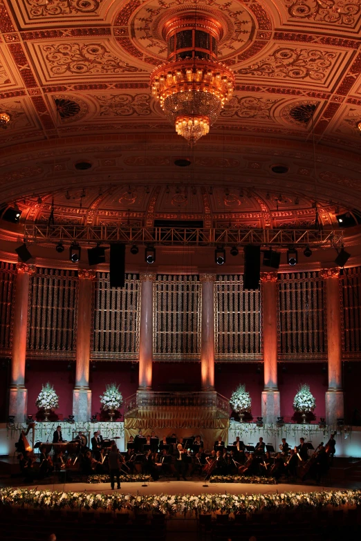 a large stage with a conductor and orchestra in it