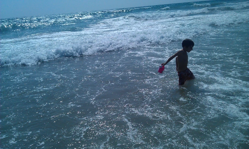 a  is in the ocean playing with a frisbee