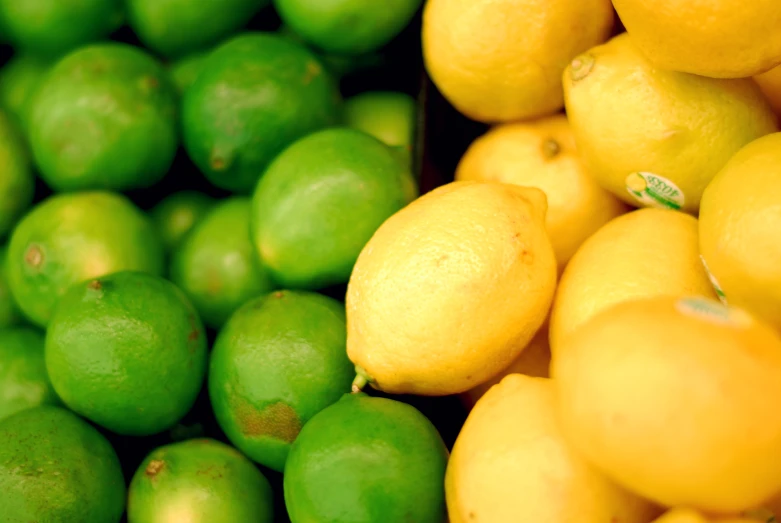 a pile of lemons and limes on display