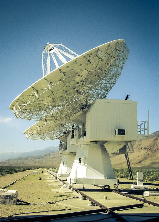 a very large antenna dish out in the middle of nowhere