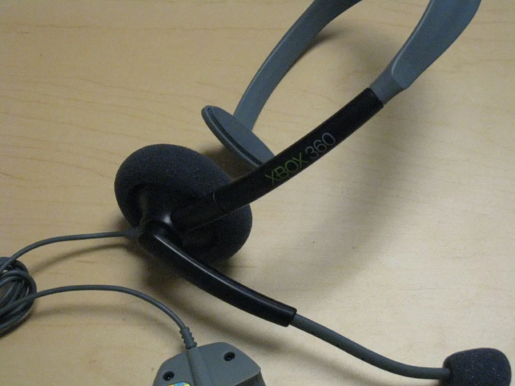 a pair of headphones connected to a cord on a desk