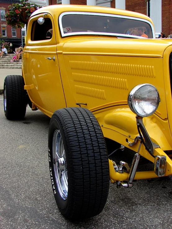 a car is painted yellow with no hood