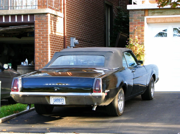 the car parked in front of the house has a back light on it