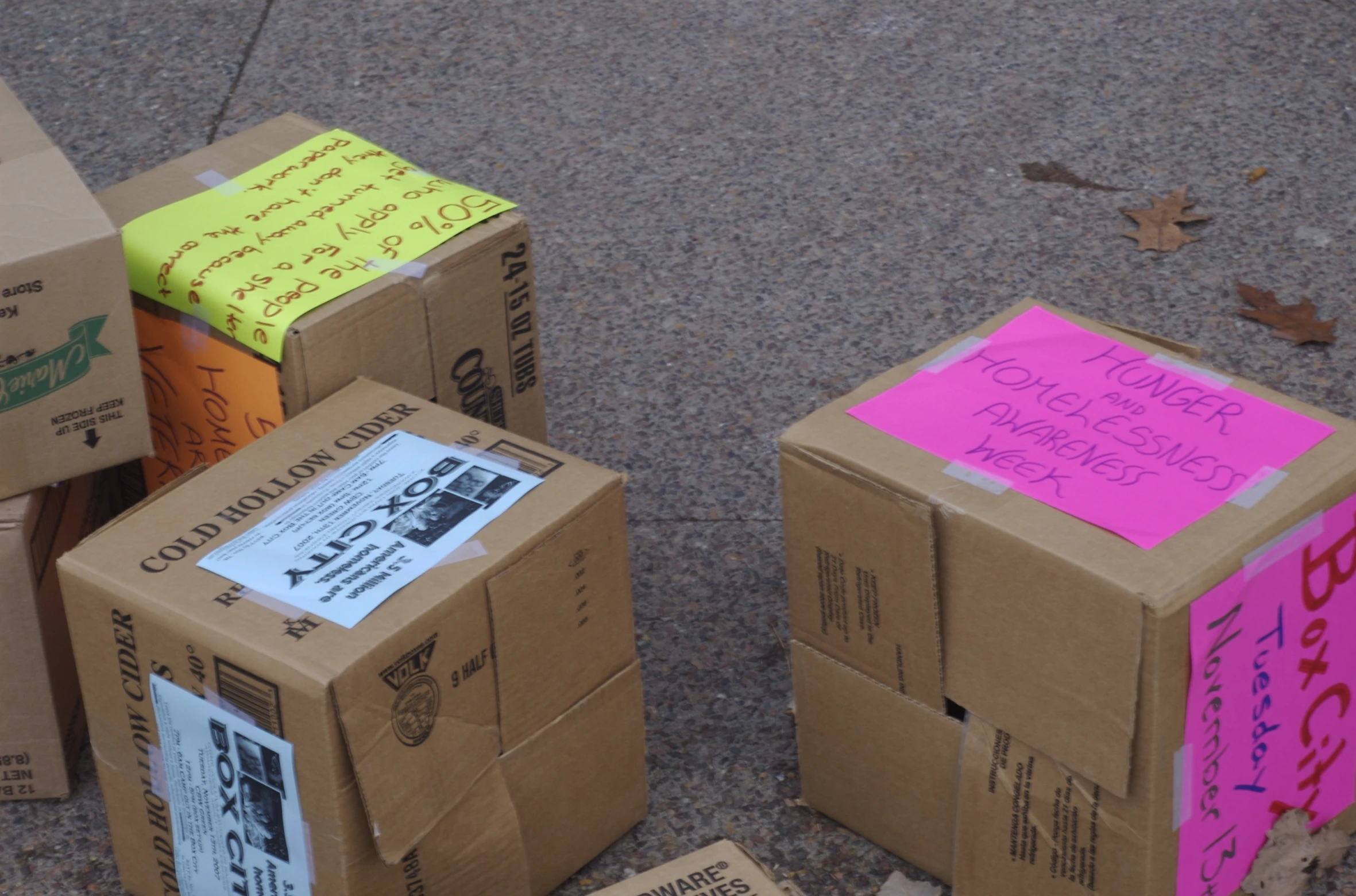 some colorful sticky notes sitting next to boxes on the sidewalk