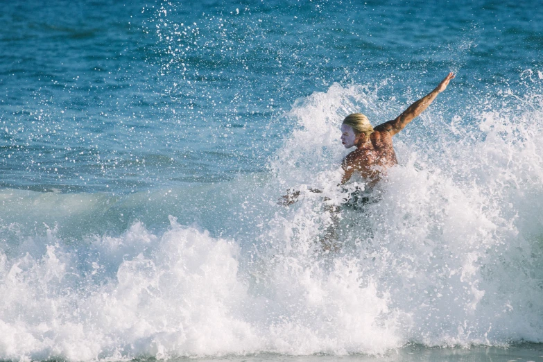 a person riding a wave on a surfboard