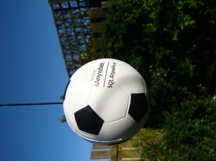 a black and white soccer ball hanging in the air