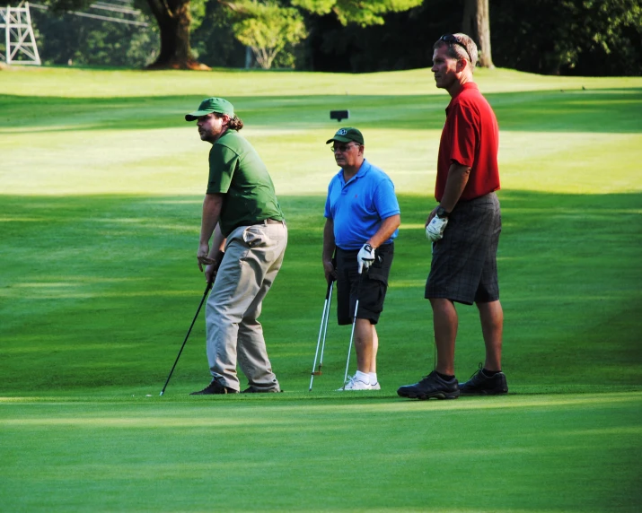 the men are talking on the golf course