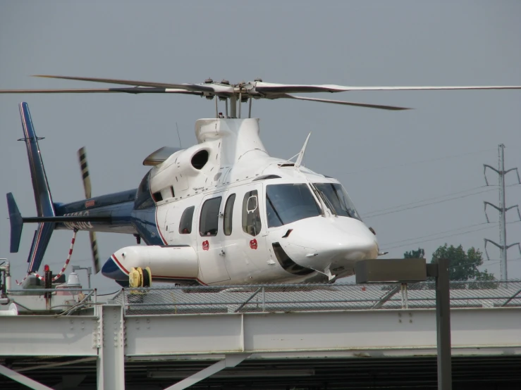 there is a helicopter on a runway near the airport