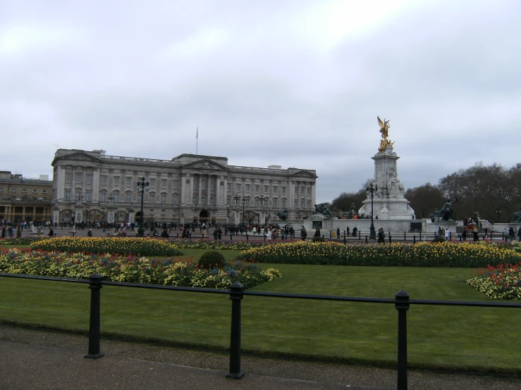 a view of a large building with a park in front