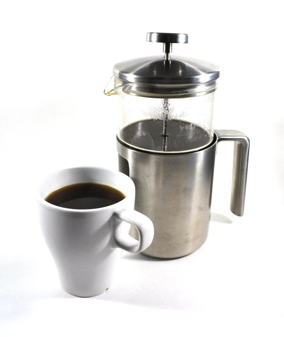 a coffee pot with a full cup of coffee