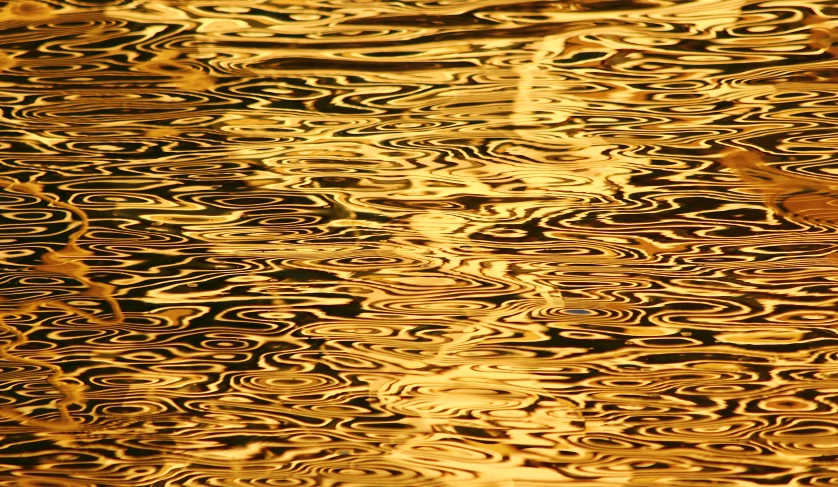 the reflection of an umbrella in the water