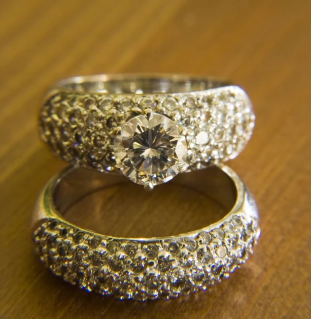 two gold and silver rings with a diamond