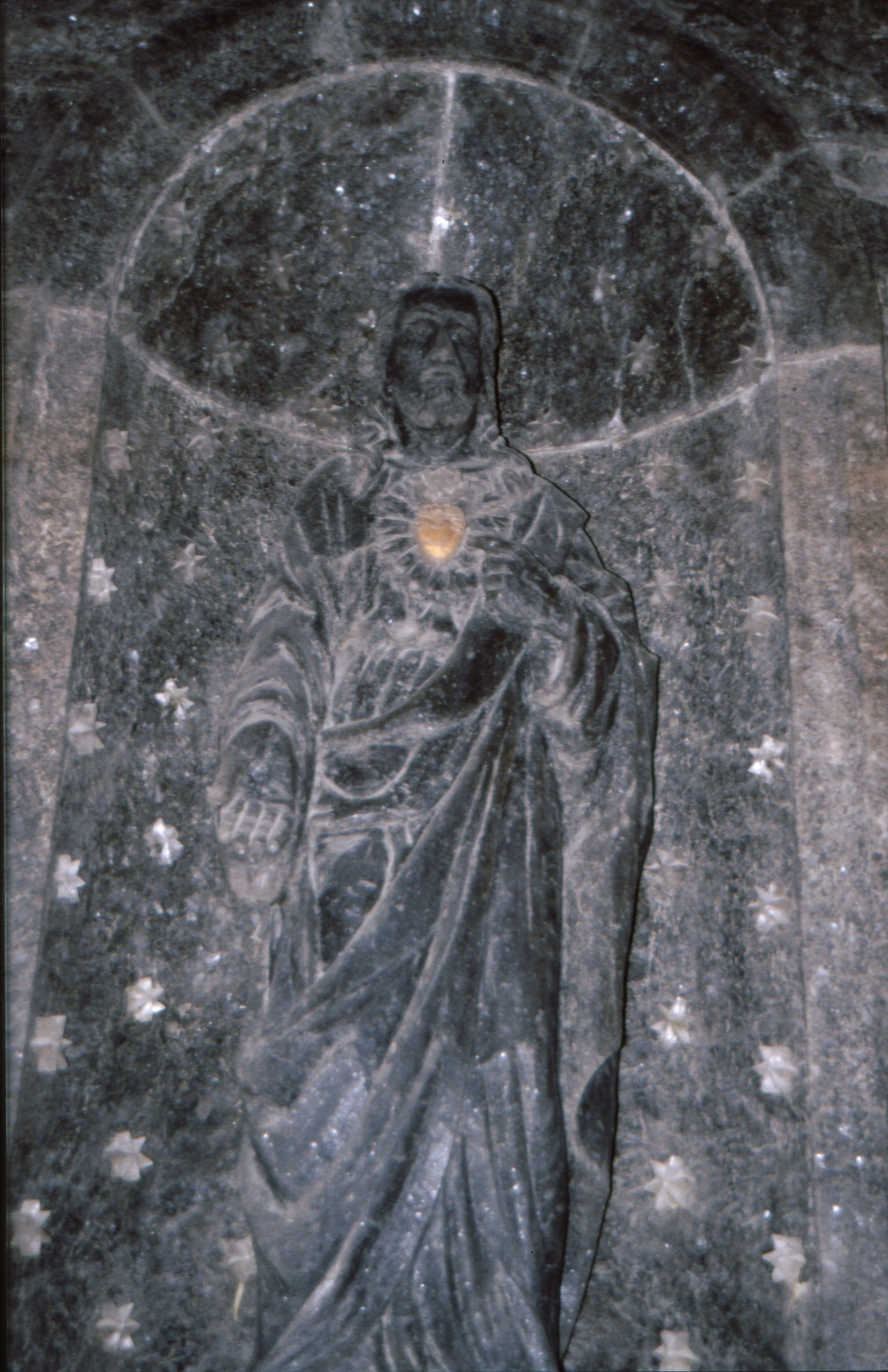 an image of jesus holding the cross with stars around it