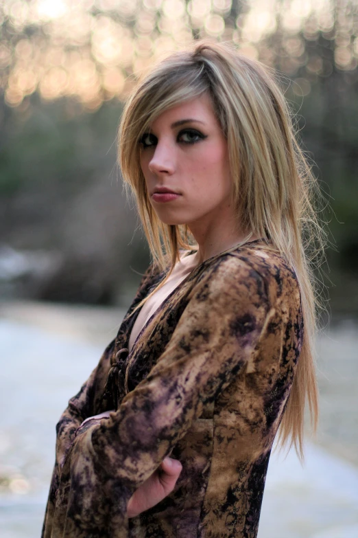 a woman with blond hair and makeup poses for a picture