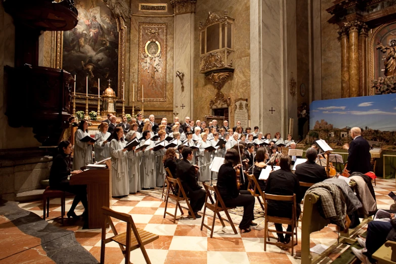 a choir of people are in an elegant cathedral