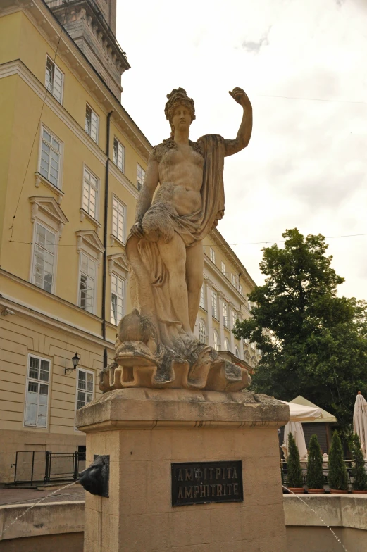 a statue in front of a very tall building