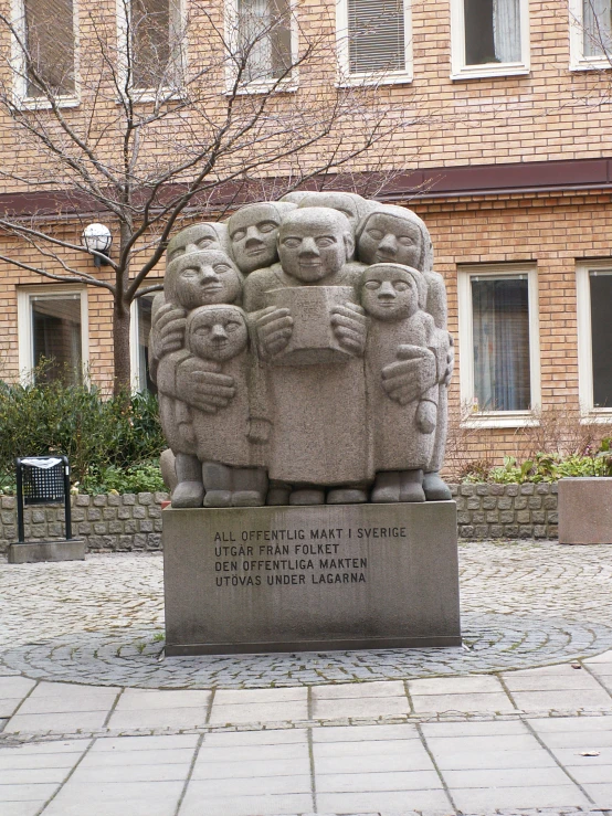 statue in front of building with brick walls in background