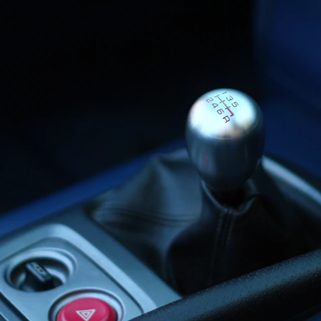 a blue and black leather car shift control