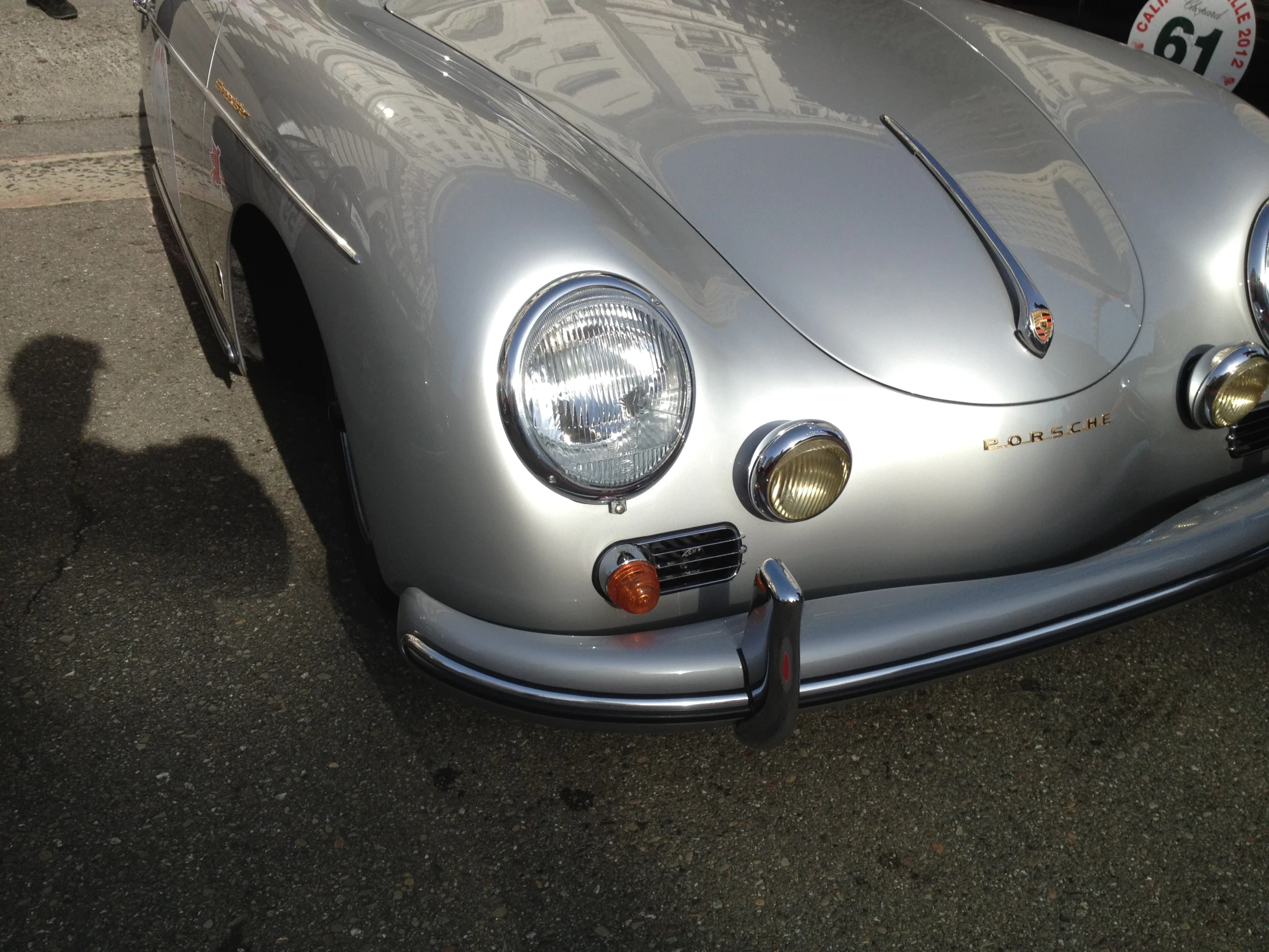 the front end of a silver porsche type car