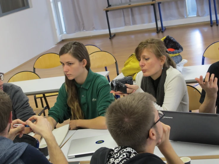 a group of people sitting around a table in a room