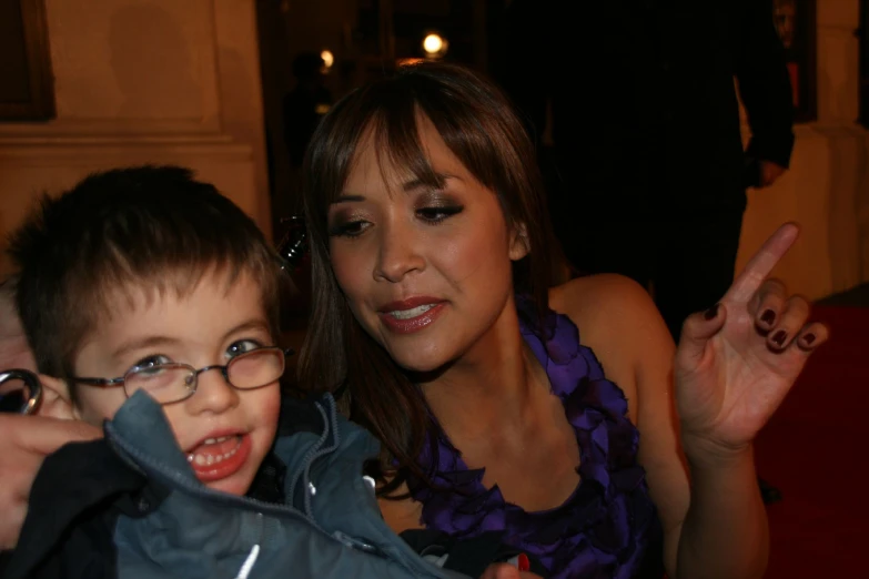 a child and woman are posing together for a picture