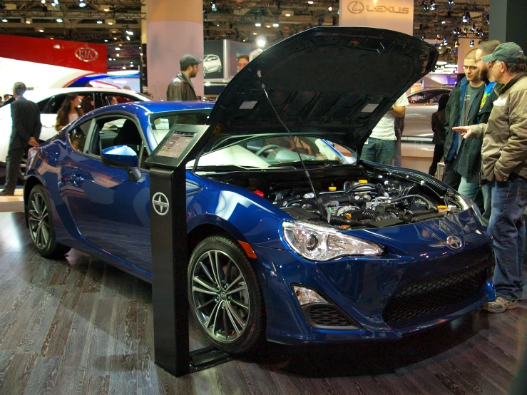 a car with its hood open sitting on display