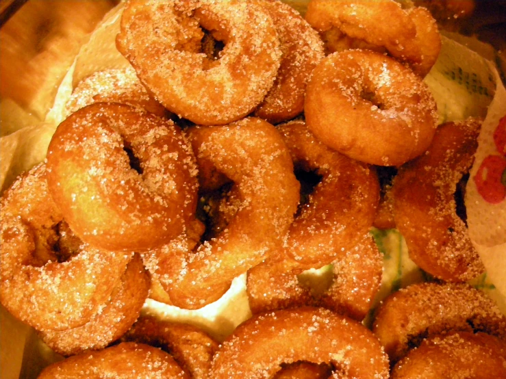 an arrangement of doughnuts sitting on a paper in a box