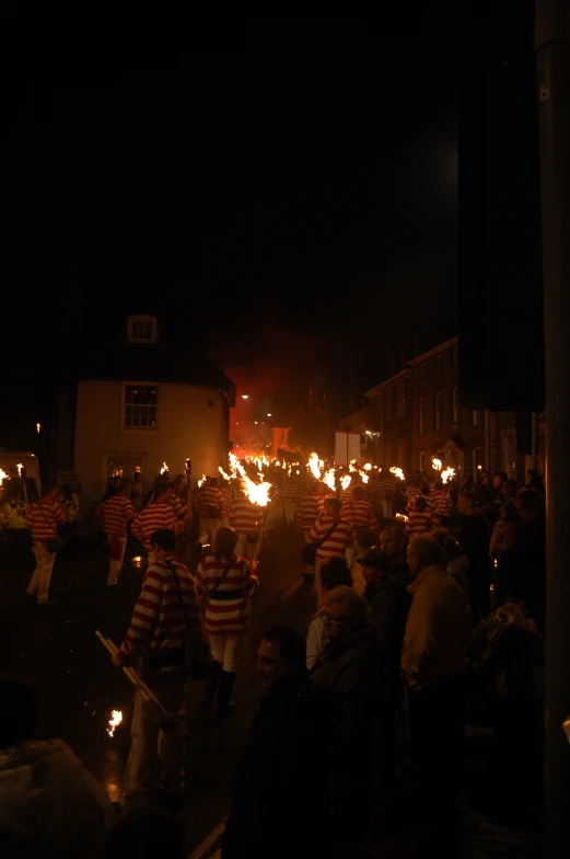 a large group of people are carrying fire torches