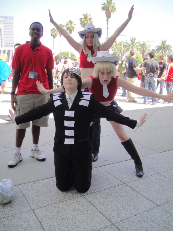 four people with hats and costumes are standing together