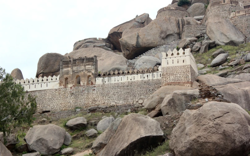 a very tall castle sitting between two big rocks