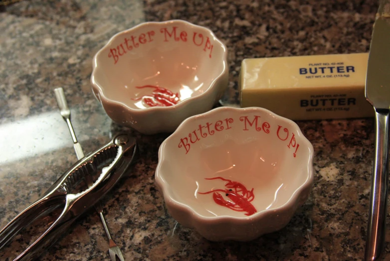 two small bowls with writing and crayon sit on the counter