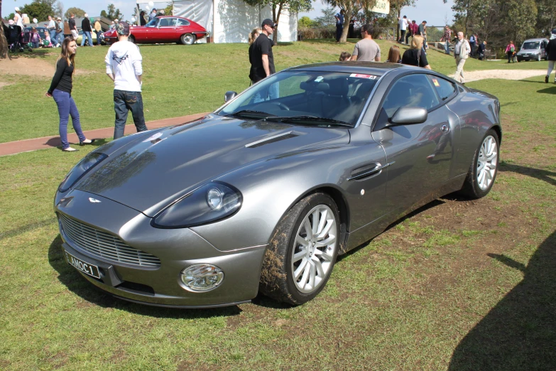 a shiny sports car parked on top of grass